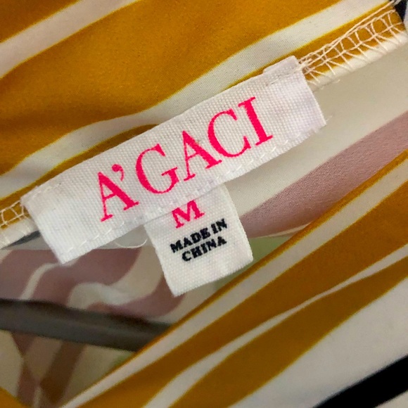 Striped top. 3/4 button sleeves. Tie back. V-neck front and back. Elastic bottom - Picture 4 of 4